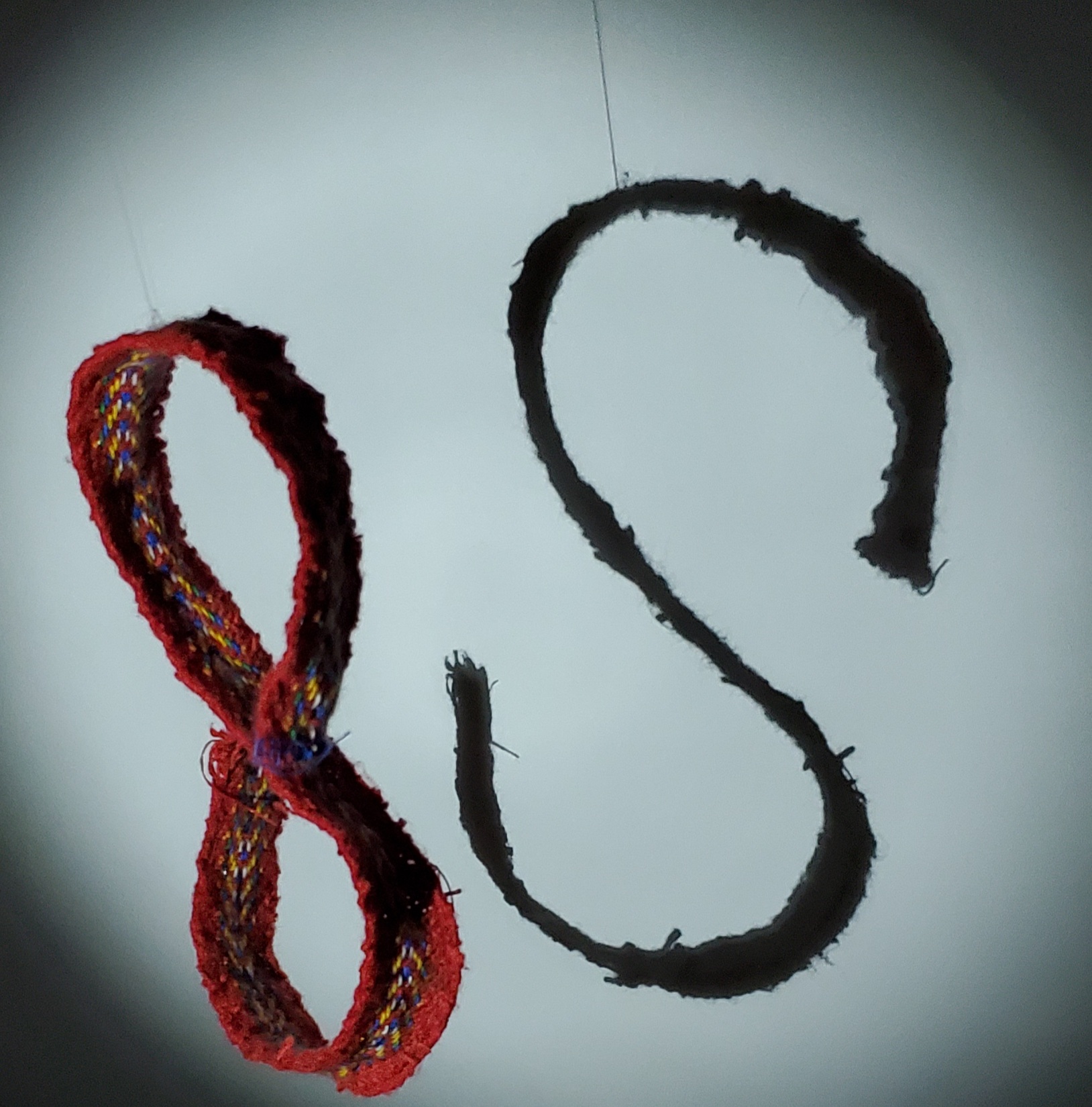 The letter 'S', made by a Métis sash