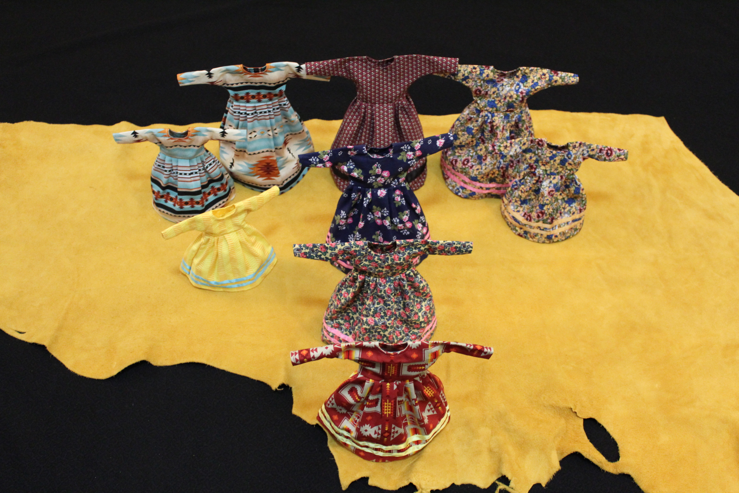 Several miniature Blackfoot dresses